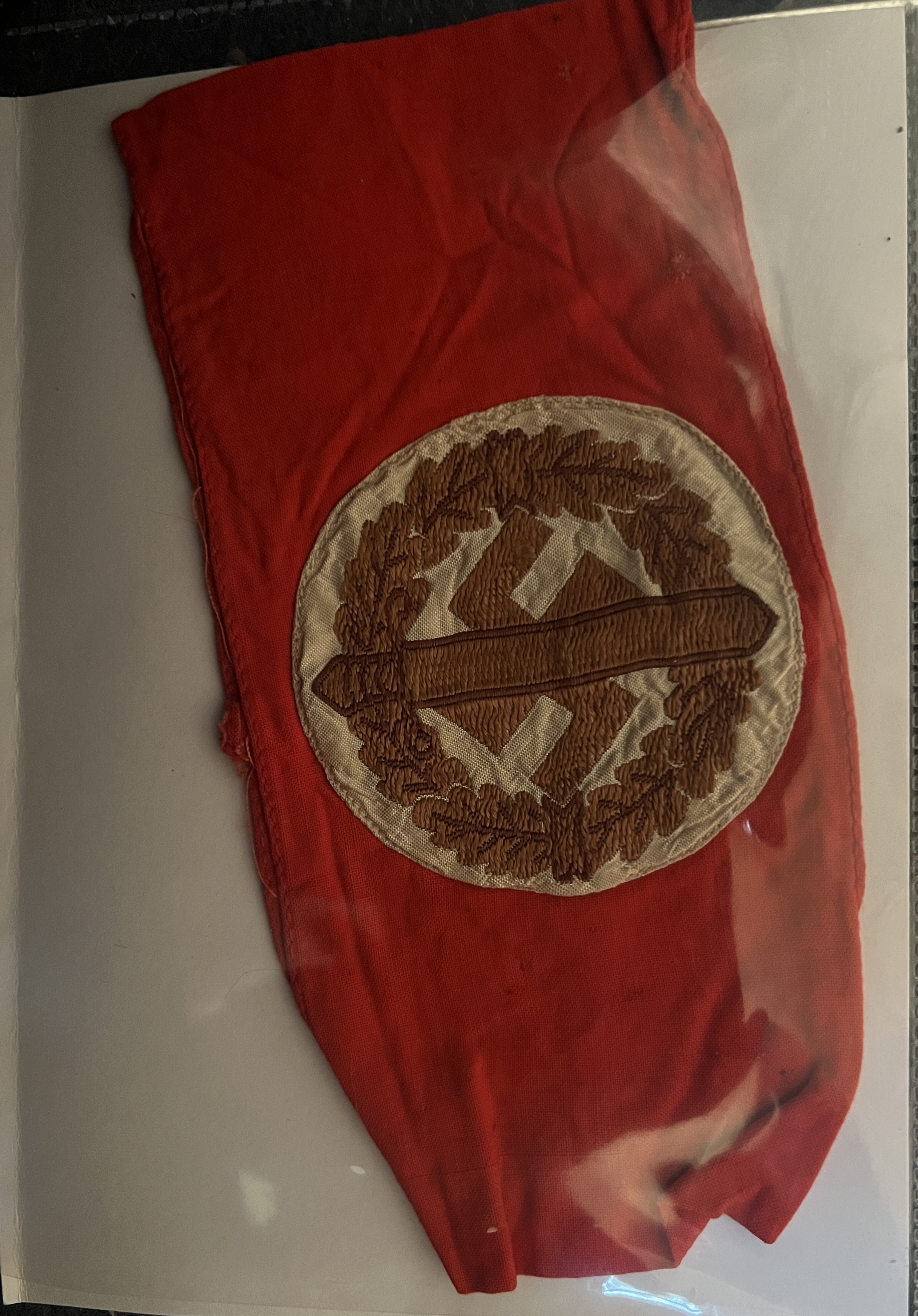 golden swastika, sword and wreath within white circle upon red band, not as bold as standard NSDAP armband