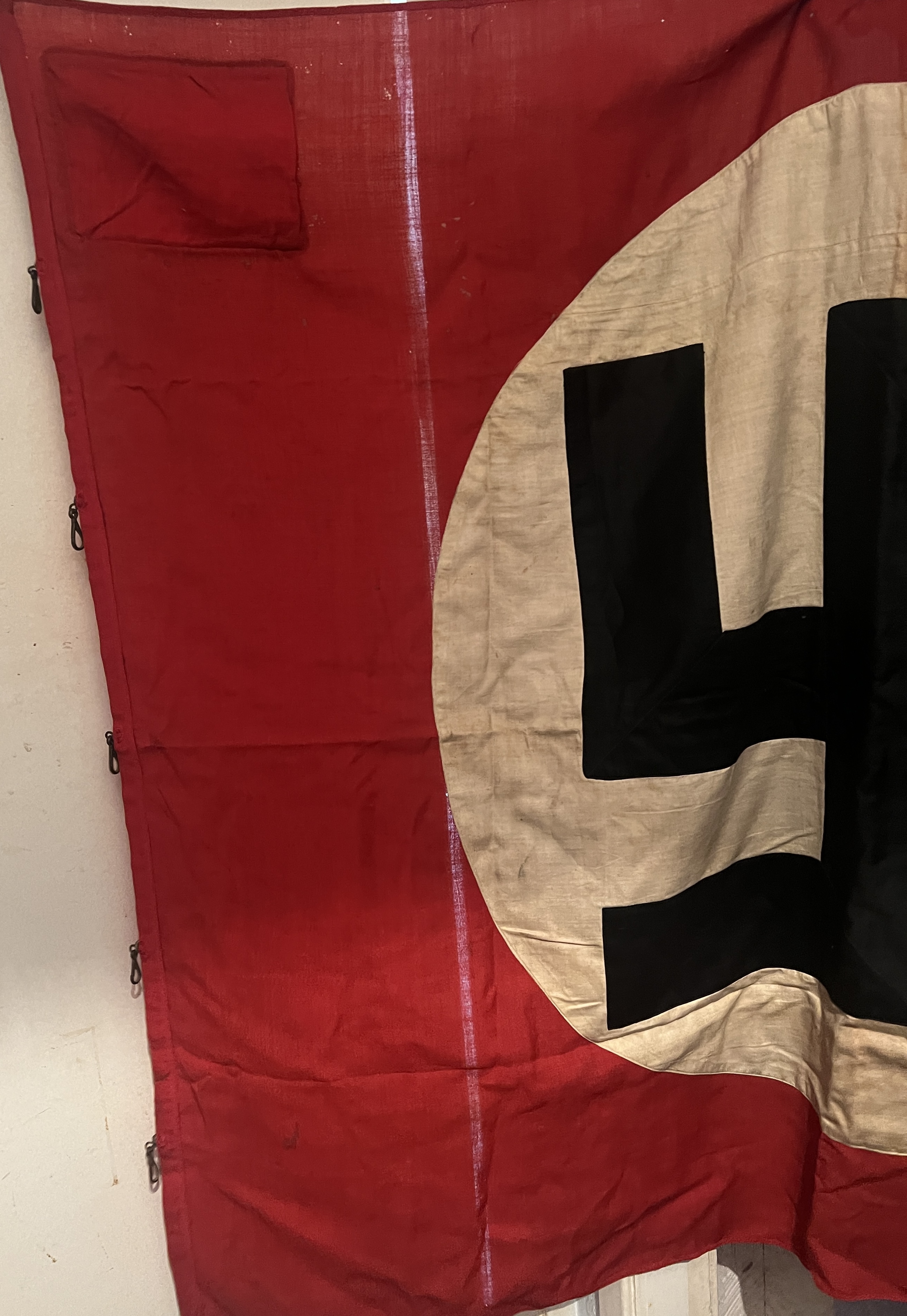 large black swastika within white circle upon red background